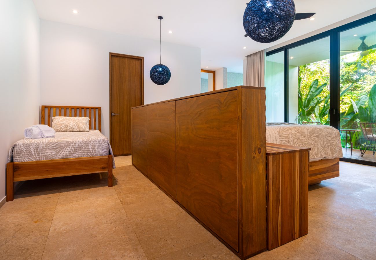 Bedroom suite with partial wall separating sleeping and seating areas