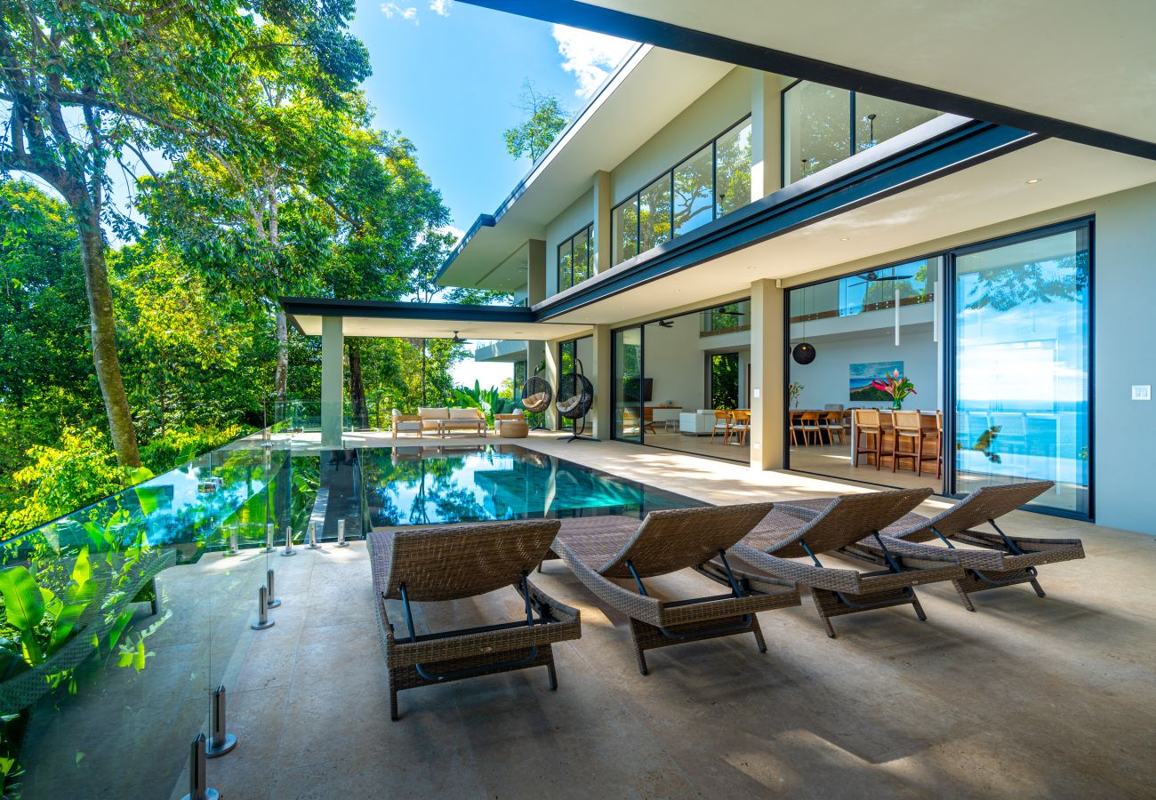 Covered outdoor seating area next to the infinity pool