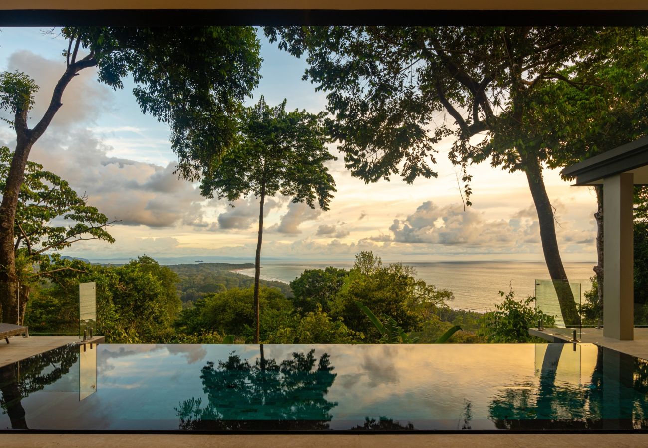 Modern hillside villa surrounded by lush jungle, overlooking the Whale’s Tail at Marino Ballena National Park.