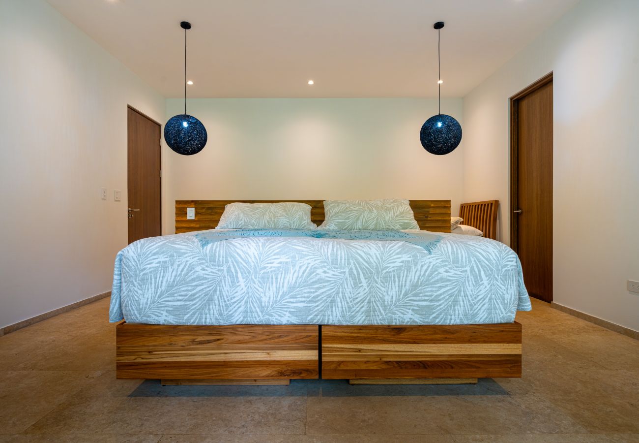 Bedroom with glass doors overlooking tropical plants