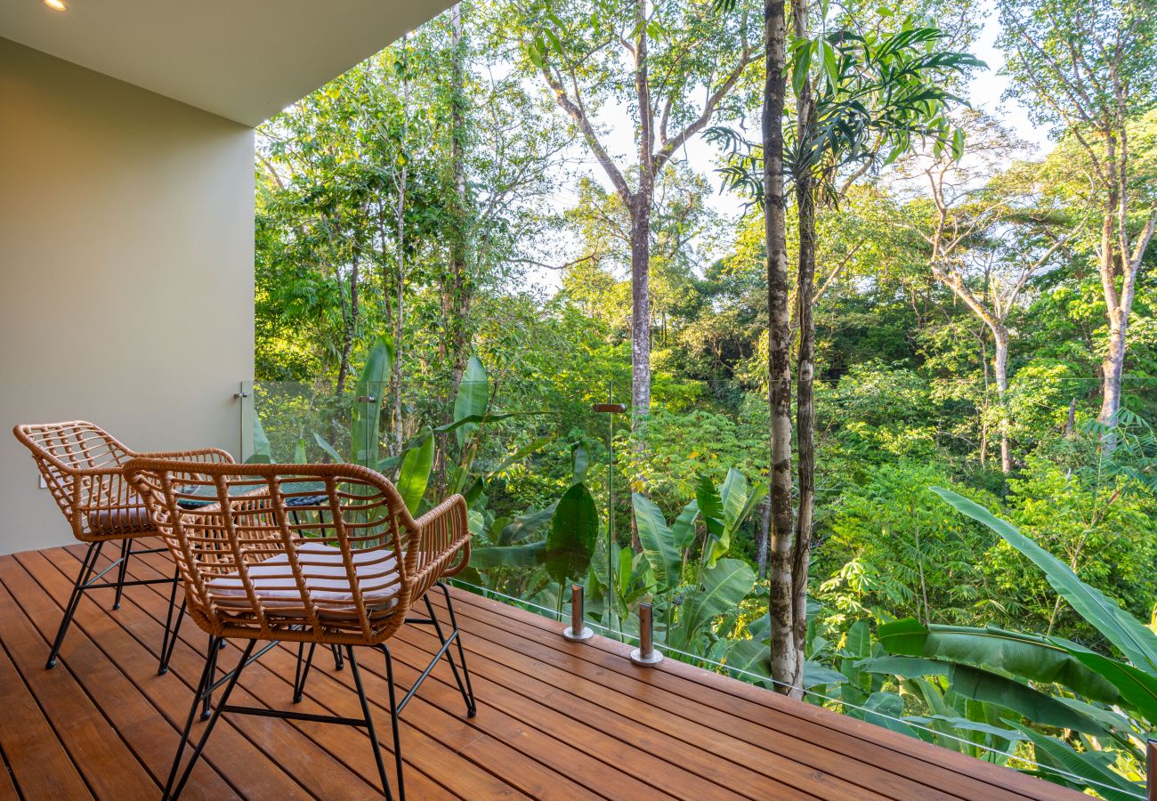 Outdoor seating area surrounded by lush greenery